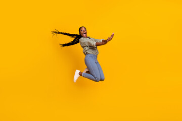Fototapeta na wymiar Full body photo of overjoyed active person have good mood jumping fall isolated on yellow color background