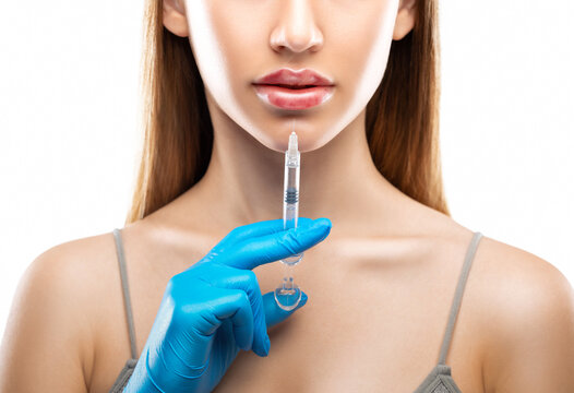 Injections for lips augmentation anti wrinkle injections on the face of a beautiful woman. Female aesthetic cosmetology in a beauty salon. Hematomas after lip contouring.