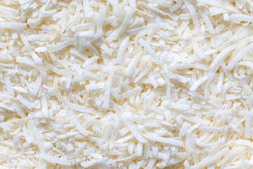 Coconut flakes background. Top view, close up of shredded white fruit