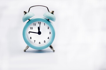 Blue alarm clock on a white background. A new year is coming. 2023. Almost midnight on the clock