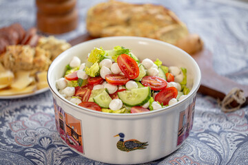 Fresh salad. Summer salad with iceberg leaves. Summer dish. Diet salad. Proper nutrition. Food on the table. Green salad. Food in the kitchen. Healthy food
