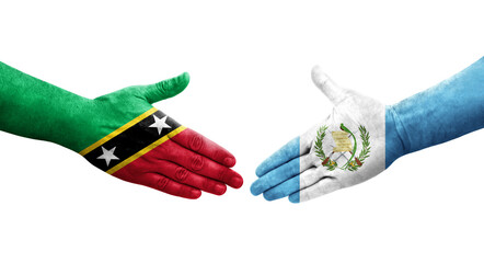 Handshake between Guatemala and Saint Kitts and Nevis flags painted on hands, isolated transparent image.