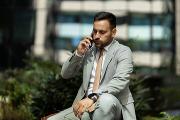 Business man on break, talking on phone and looking worried