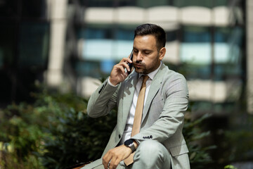 Business man on break, talking on phone and looking worried