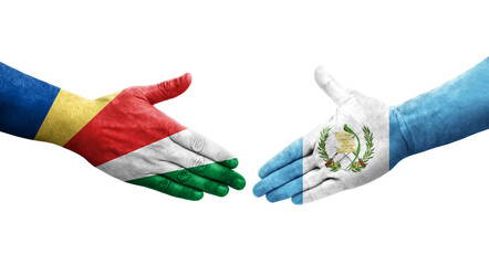 Handshake between Guatemala and Seychelles flags painted on hands, isolated transparent image.