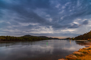 Sunrise with rain clouds over the bay