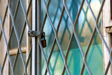 Window with metal grille locked from the inside