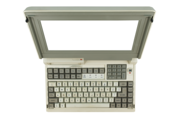 Overhead perspective of vintage laptop computer wiith transparent monitor screen.