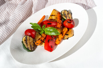 Vegetable salad with grilled red capsicum, sweet potato, zucchini and parsley.