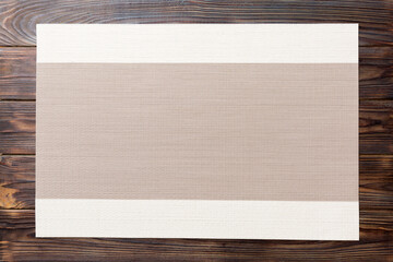 Top view of grey tablecloth for food on wooden background. Empty space for your design
