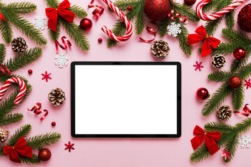 Top view of empty tablet on Christmas background made of new year decorand festive decorations. New year holiday concept. Mockup