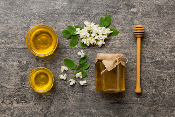 honey jar with acacia flowers and leaves. fresh honey top view flat lay