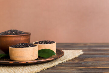 quinoa seeds in bowl on colored background. Healthy kinwa in small bowl. Healthy superfood
