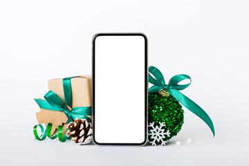 Digital phone mock up with rustic Christmas decorations for app presentation with empty space for you design. Christmas online shopping concept. Tablet with copy space on colored background