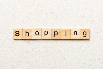 shopping word written on wood block. shopping text on cement table for your desing, concept