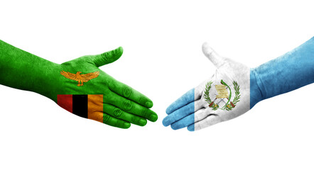 Handshake between Guatemala and Zambia flags painted on hands, isolated transparent image.