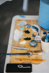 Close view of painter's palette with tools on the table
