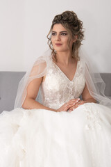 Fototapeta na wymiar Portrait of a beautiful bride wearing wedding dress posing and smiling