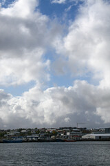 Fototapeta na wymiar Reykjavik, Iceland - Reykjavik’s coastline, under a cloudy blue sky. Image has copy space.