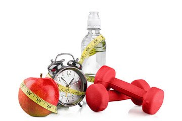 Green alarm clock, apple, bottle of water,  measuring tape and dumbbells as concept of diet -...