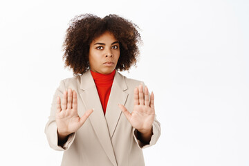 Corporate people. Serious african american woman shows stop, prohibit gesture, refusing smth,...