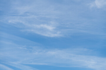 Beautiful white cirrus clouds on blue sky. Natural background. Weather forecast. Copy space for your text and decorations. Beauty in nature theme.