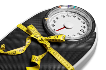 Bathroom scale with a measuring tape on background