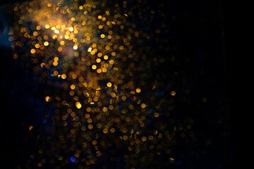 Defocused bright golden and dark blue bokeh dots abstract overlay and background