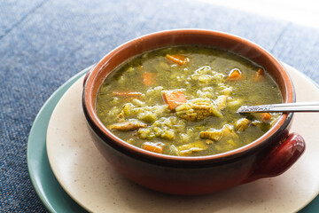 Peruvian food soup with cilantro, carrots and chicken called aguadito. 