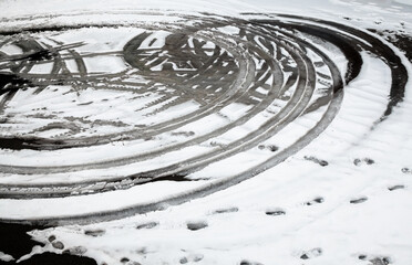 Fototapeta na wymiar Wheel tracks on the road covered with snow