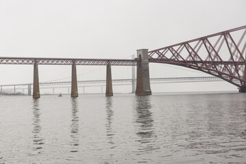 View of the George IV Bridge Rail Bridge across the water of the Firth of Forth in an overcast...