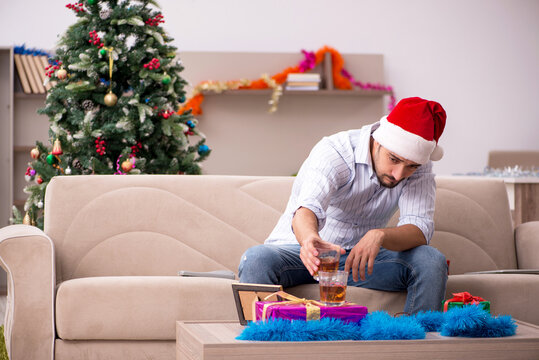Young man celebrating Christmas at home alone