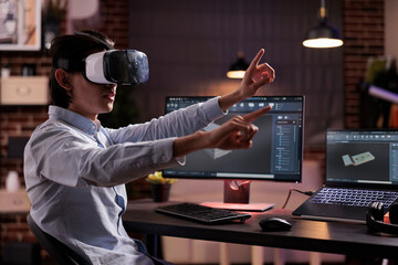 Male freelancer using vr glasses on industry production, engineering technical product with virtual reality headset and computer. Developing machinery engine component with cad software app.