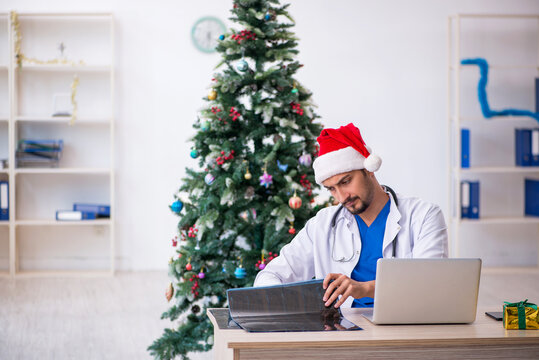 Young male doctor celebrating Christmas at the hospital