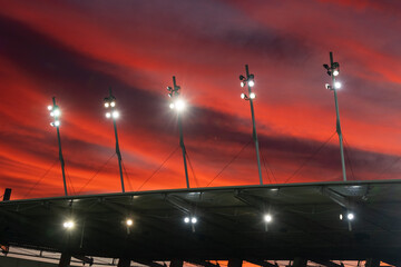 Stadium roof spotlights with a beautiful colorful sky at dusk.