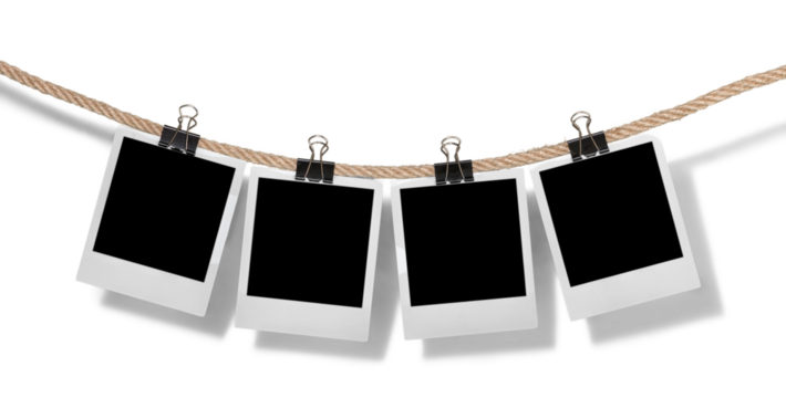 Hanging instant photo frames on brick wall background