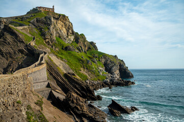 Fototapeta na wymiar Stone footpath to famous landmark and film location in North of Spain, ocean islet with chapel San juan de gaztelugatxe, Basque Country, Spain
