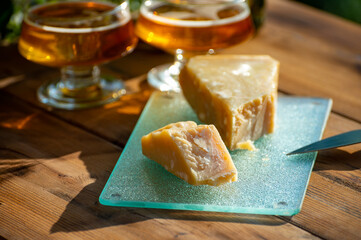 Cheese pairing with drinks,  parmigiano reggiano or parmesan cheese and French apple cider served outdoor