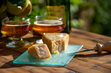 Cheese pairing with drinks,  parmigiano reggiano or parmesan cheese and French apple cider served...