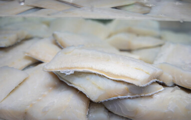 White salted and dried bacalao codfish is watertank, traditional Spanish food on display in fish...