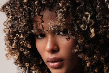 Close-up of African American young woman with afro hair looking at the camera.