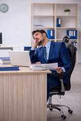 Young male employee working in the office