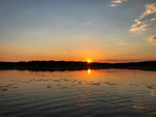View of the sunset on the lake with water lilies on the water. Tourism, travel and vacation concept.