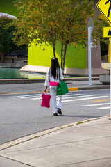 an African American woman with long sisterlocks wearing white and pink clothes, sunglasses and an...