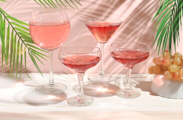 Modern still life with white wine, alcoholic margarita cocktail and grapes on a pastel background with long hard shadows, minimal concept for a bar, cafe, advertising banner, selective focus