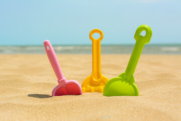 Fototapeta na wymiar Set of colorful beach toys on sand near sea