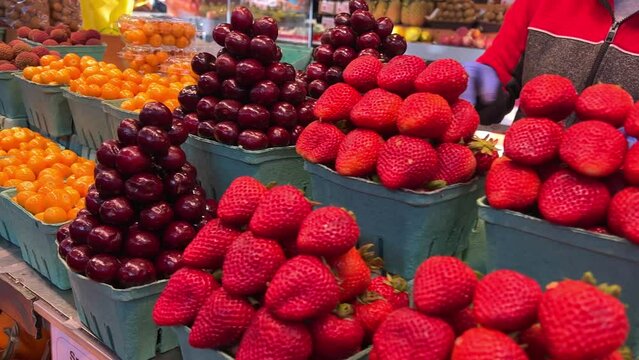 Many containers containing lots of strawberries. The garden strawberry is a widely grown hybrid species of the genus Fragaria. High quality 4k footage