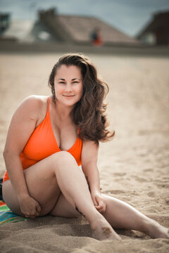 beautiful woman 40 years old on the beach in plus size swimsuit