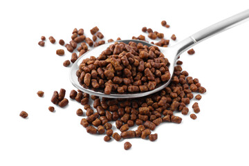 Spoon with buckwheat tea granules on white background