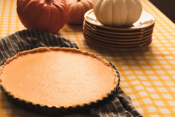 Delicious homemade pumpkin pie in baking dish on table
